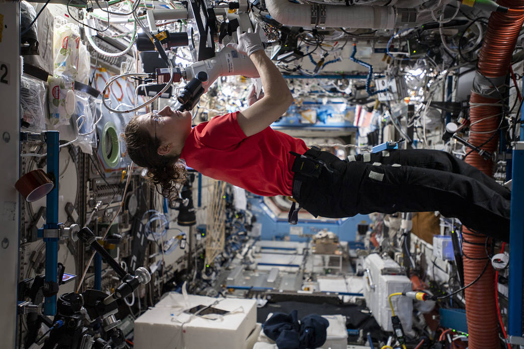 NASA astronaut handling equipment for protein crystal research aboard the ISS.